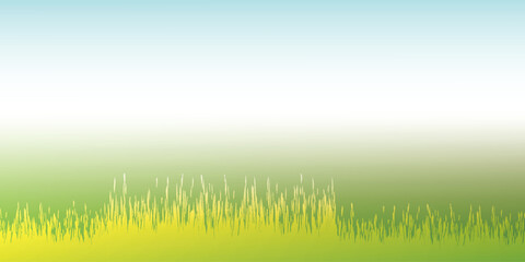Fototapeta premium Vibrant green grass field with a clear blue sky background.