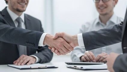 Fototapeta premium Close up view of two businessmen shaking hands during a meeting