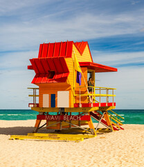 Fototapeta premium Miami Beach. Lifeguard tower on South Miami Beach. Miami Beach coastline. Famous Beach lifeguard. Travel to Miami. Art Deco lifeguard on Miamis shoreline. Jetty lifeguard tower.