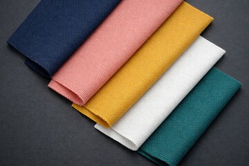 Textile Spectrum: A captivating array of vibrant textiles, carefully arranged to showcase their unique colors and textures, inviting a sensory exploration of fabric.