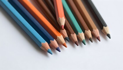 Fototapeta premium Arrangement of colorful wooden drawing pencils on a white surface