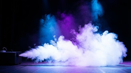 Stage fog machine creating dynamic smoke effect with blue and purple light