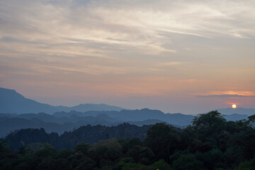 Fototapeta premium Sunset Over Layered Karst Mountains from Limestone Forest Viewpoint, Thakhek Loop, Laos
