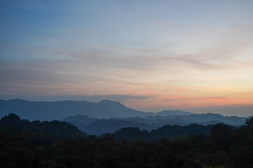 Fototapeta premium Sunset Over Layered Karst Mountains from Limestone Forest Viewpoint, Thakhek Loop, Laos