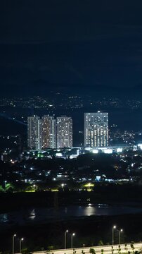 Vertical video - Timelapse of night view of an apartment complex in Jakarta outskirt (BSD)