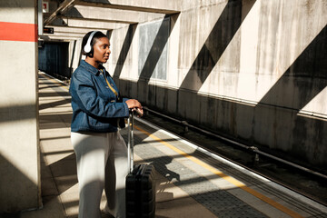 Young black woman waiting for train at underground station