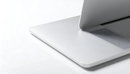 Close-up of a laptop's corner, showing the keyboard, trackpad, and opened screen, on white
