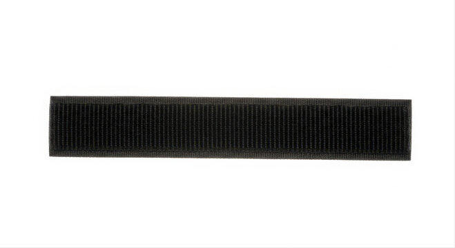 Black velcro strip isolated on a white background showcasing texture and detail