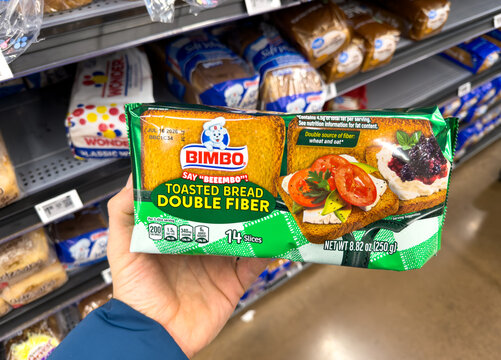 Bimbo Double Fiber Toasted Bread Package Held in Grocery Store