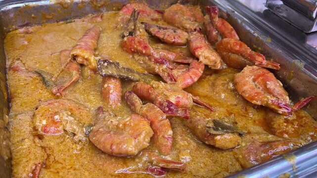 Chingri malai curry served in an Indian wedding