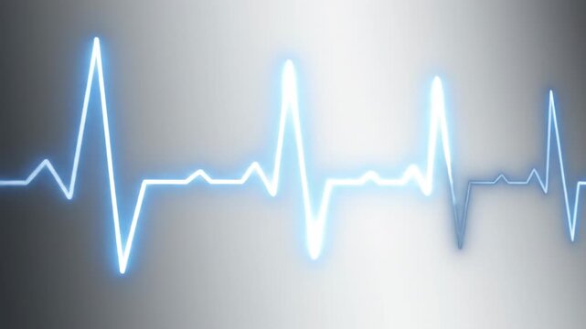 A blue electrocardiogram reading displayed on a gradient gray background with a shallow depth of field.