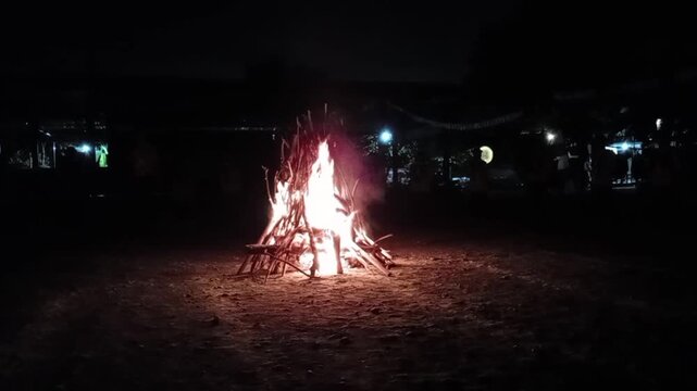 A campfire lit at night at a scout camp
