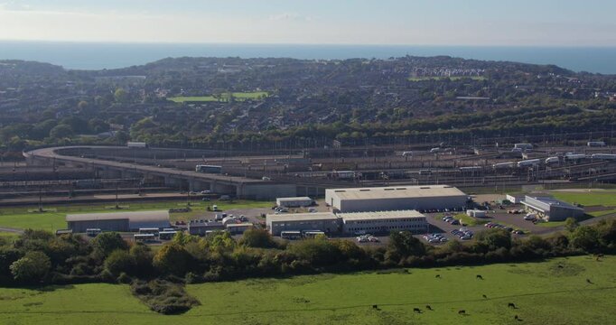 Extra wide shot of cars and lorries driving off the Eurotunnel train at Folkestone UK