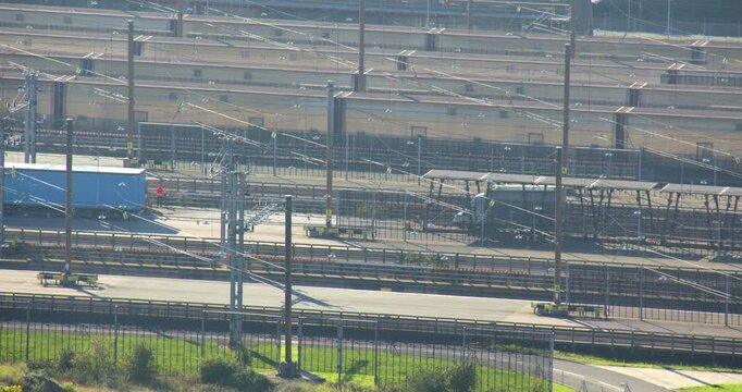 Long shot of lorries driving off the Eurotunnel train at Folkestone UK