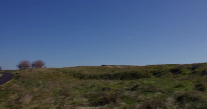Wide panning shot onto the abbot's Cliff sound mirror