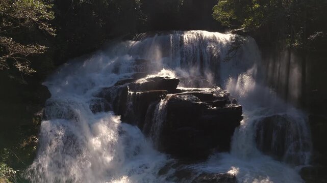 Slow fly backwards with view of Sirithan Waterfall upstream, Thailand