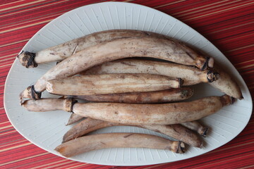 Whole farm fresh Lotus root, also known as renkon, nandru is the edible rhizome of the sacred lotus plant, Nelumbo nucifera, traditional Asian cooking ingredient © Pravruti