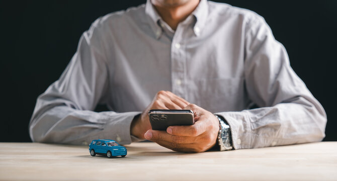 Man holds smartphone, navigating online car marketplace for shopping, comparing auto purchase options, evaluating auto acquisition, modern digital platform for vehicle selection