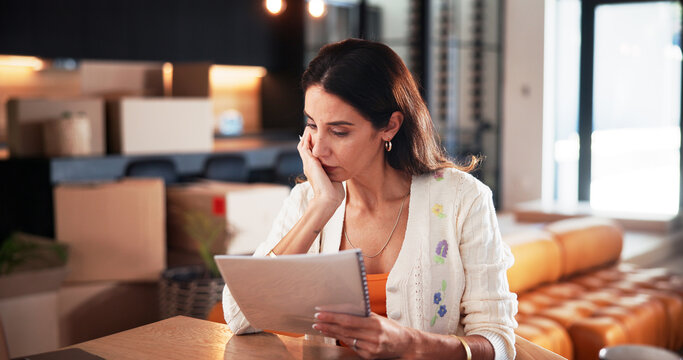 Concern, woman and reading document at new house for property purchase, agreement and hidden fees. Worry, female person and contract with legal terms, lease cost and review information for relocation