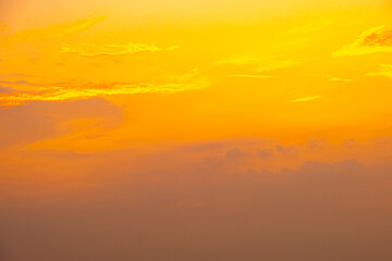 Fototapeta premium Panorama of dramatic golden sunset sky with dark storm clouds and sun rays, cinematic nature background 