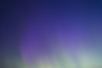 Obraz premium Vibrant night sky with aurora borealis and starry cosmos over dark landscape