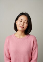 Fototapeta premium Smiling Asian Woman Wearing Pink Sweater.