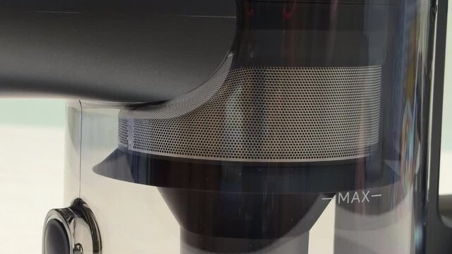 The vacuum motor spins rapidly to create intense suction through the filter mesh. This high-speed action generates a consistent, high-pitched whine and a powerful rushing air sound.