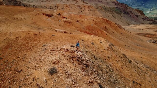Happy Traveler hipster man with backpack in hat doing adventure background mountains Altai Republic Mongolia Mars valley.