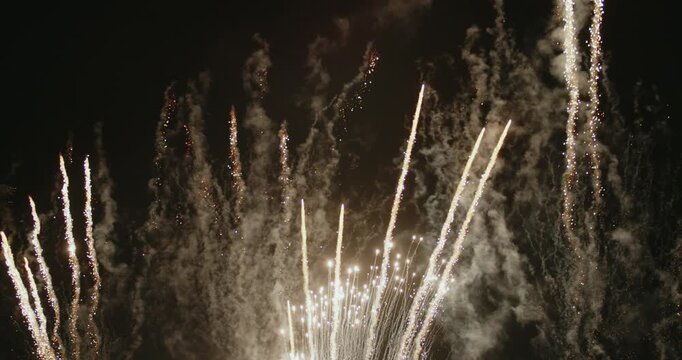 Close-up fireworks captured with a telephoto lens from short distance. Colorful explosions illuminating the night sky during the festive celebration of fallas in Valencia (nit del foc).