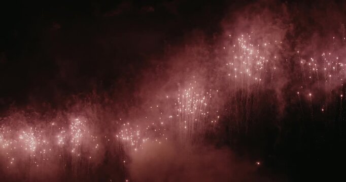 Close-up fireworks captured with a telephoto lens from short distance. Colorful explosions illuminating the night sky during the festive celebration of fallas in Valencia (nit del foc).