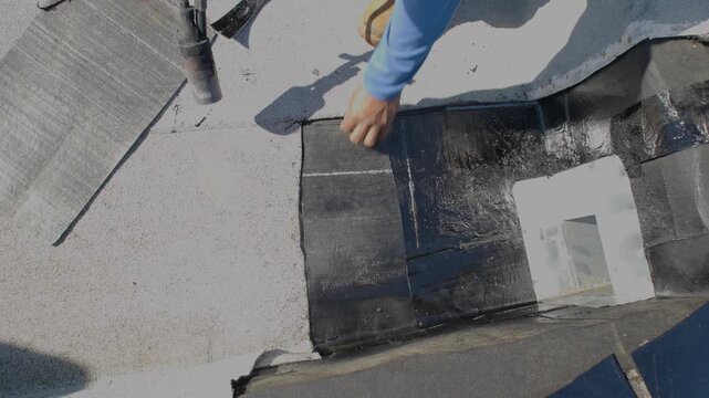 Cutting a piece granulated APP Torch Down
