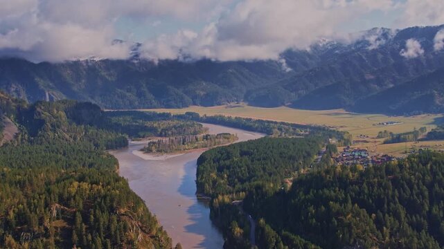Aerial view sunrise landscape on meandering river Katun with fog and blue sky Altai Mountains, Russia.