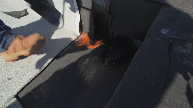 Roofer applying granulated APP Torch Down