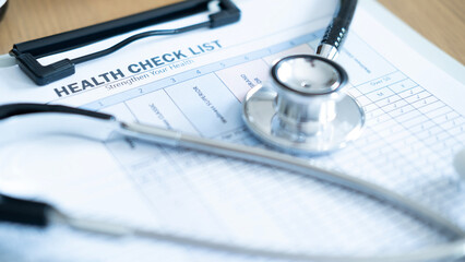 Stethoscope placed on health check list clipboard with copy space, concept of annual physical checkup, preventive healthcare and medical examination service. © Jokiewalker
