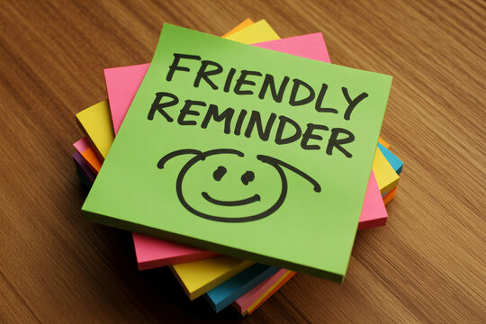 A stack of colorful sticky notes with a friendly reminder message on top.