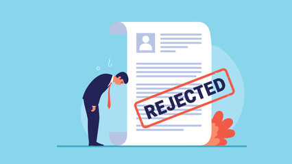 Disappointed job applicant bows his head in sadness next to a large resume document marked with a red rejected stamp.