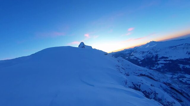 Majestic Aerial View of Snow Covered Mountain Peak atBlue Hour Twilight with Pik Sky Gradient