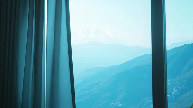 Window frames layered blue mountain ranges under a hazy sky, offering a tranquil panoramic vista from a modern room serene landscape perfect for relaxation and travel