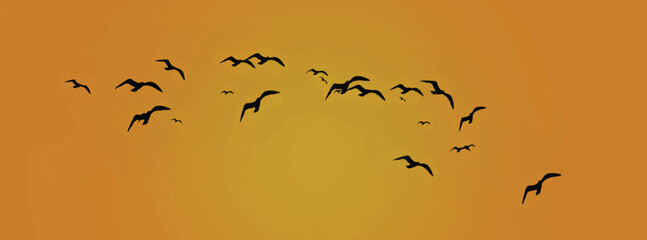 Fototapeta premium Silhouettes of flock of birds flying against the sky 
