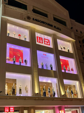 Ho chi minh, Vietnam - February,15, 2026: A modern shopping plaza with bright illuminated displays showcasing mannequins in various outfits in Uniqlo store.