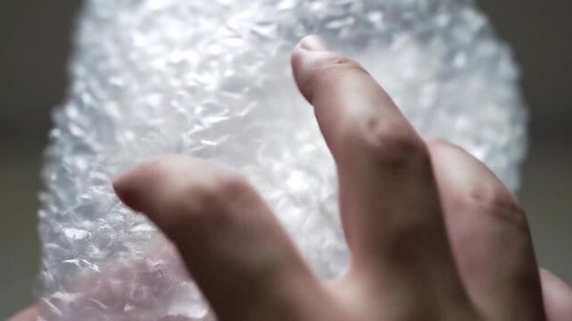 Hands Popping Bubble Wrap Packaging Material.