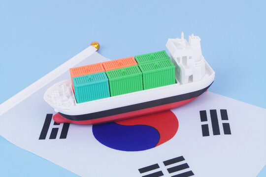 Cargo ship with many containers with Korean flag on blue background.	