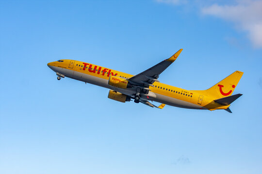 Yellow TUI aircraft after takeoff from Madeira Funchal Airport, Portugal