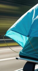 Blue tent on car roof during travel.