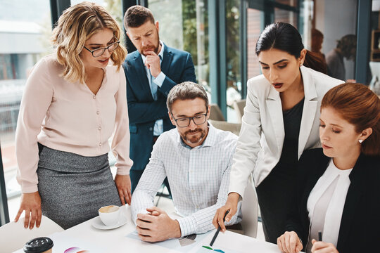 Woman, team and review with documents at office meeting for graphs, point or feedback at insurance company. Business people, group and talk with insight, solution or charts at risk management agency