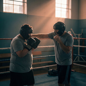 Training session between two boxers in a gym with sunlight