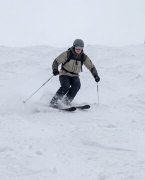 Skiing on snowy slopes during winter in a cold mountain area