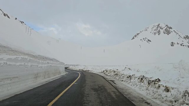 Enjoying a drive along a winding snow-covered mountain road with high snow walls, snowy hills, rugged peaks, and an overcast sky in a remote winter landscape.
📍Hawraman Takht, Kurdistan 