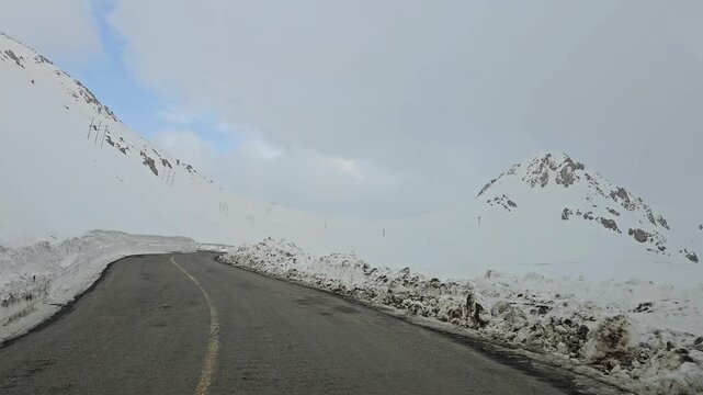 Enjoying a drive along a winding snow-covered mountain road with high snow walls, snowy hills, rugged peaks, and an overcast sky in a remote winter landscape.
📍Hawraman Takht, Kurdistan 
