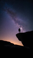 Fototapeta premium Solitary figure contemplates a breathtaking sunset merging into a starry galactic vista